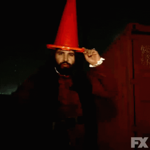 A Man With A Beard Wearing An Orange Cone And The Words We Drank The Blood Of Some People On The Bottom GIF