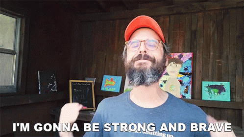 A Man With A Beard Wearing An Orange Hat And Glasses Says I 'M Gonna Be Strong And Brave GIF
