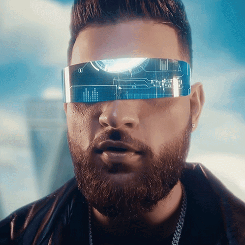 A Man With A Beard Wearing Futuristic Glasses With The Letter A On The Lens GIF