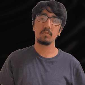 A Man With A Beard Wearing Glasses And A Blue Shirt GIF