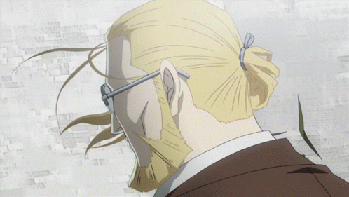 A Man With A Beard Wearing Glasses And A Suit GIF