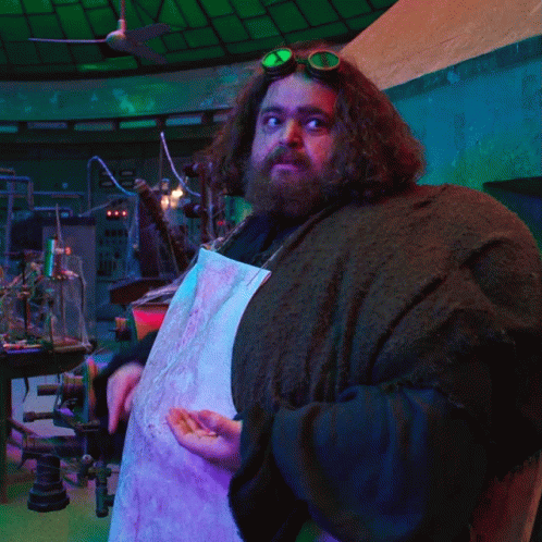 a man with a beard wearing goggles and a white apron
