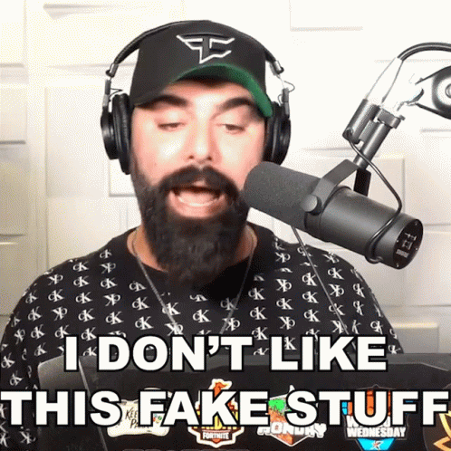 A Man With A Beard Wearing Headphones And A Hat Says I Don 'T Like This Fake Stuff GIF