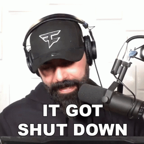 A Man With A Beard Wearing Headphones And A Hat Says It Got Shut Down GIF
