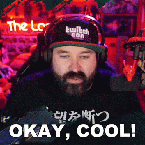 A Man With A Beard Wearing Headphones And A Hat That Says Twitch Con 2022 GIF