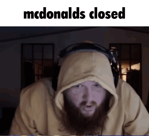 A Man With A Beard Wearing Headphones And A Hoodie Says Mcdonald 'S Closed GIF