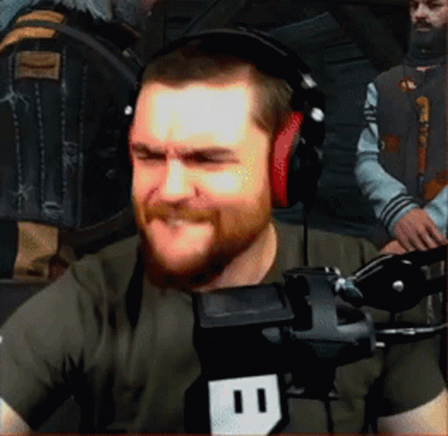 A Man With A Beard Wearing Headphones And A Microphone With The Number 11 On It GIF