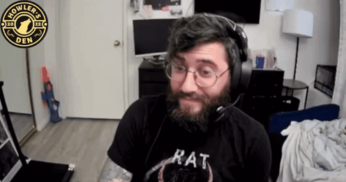A Man With A Beard Wearing Headphones And A Rat Shirt GIF