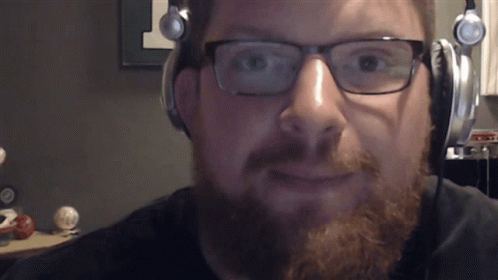 A Man With A Beard Wearing Headphones And Glasses GIF