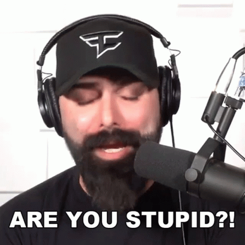 A Man With A Beard Wearing Headphones Says Are You Stupid GIF