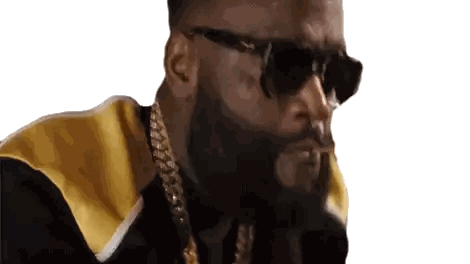 a man with a beard wearing sunglasses and a gold chain .