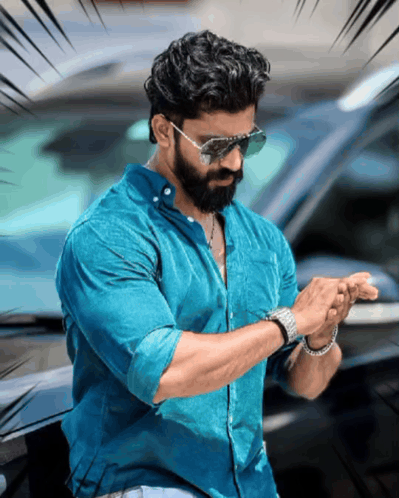 A Man With A Beard Wearing Sunglasses And A Watch Looks At His Watch GIF