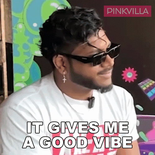 A Man With A Beard Wearing Sunglasses And Earrings Says It Gives Me A Good Vibe GIF