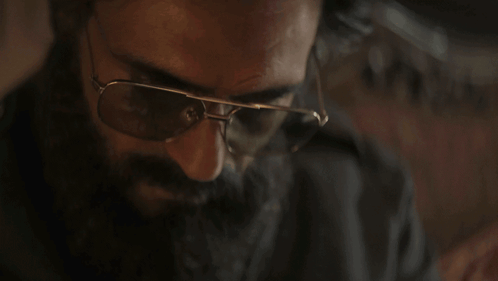 a man with a beard wearing sunglasses and the words you think