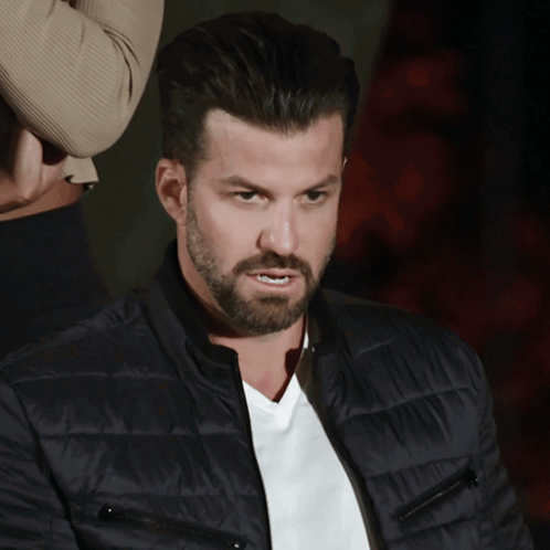 A Man With A Beard Wears A Black Jacket And A White Shirt GIF