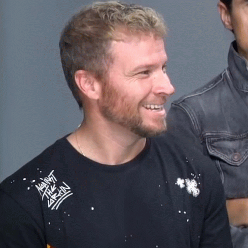 A Man With A Beard Wears A Black Shirt That Says Against Brain GIF