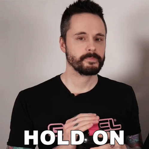 A Man With A Beard Wears A Black Shirt That Says " Hold On " GIF