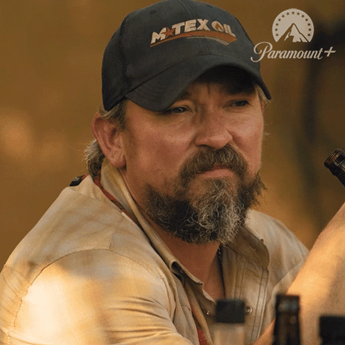 A Man With A Beard Wears A Hat That Says Mtex Oil GIF