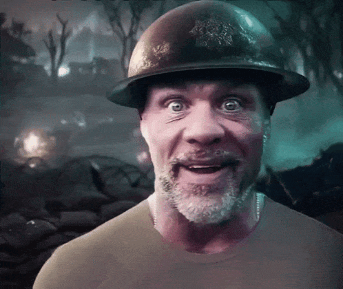A Man With A Beard Wears A Helmet And Looks Surprised GIF
