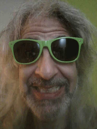 A Man With A Beard Wears Green Sunglasses GIF