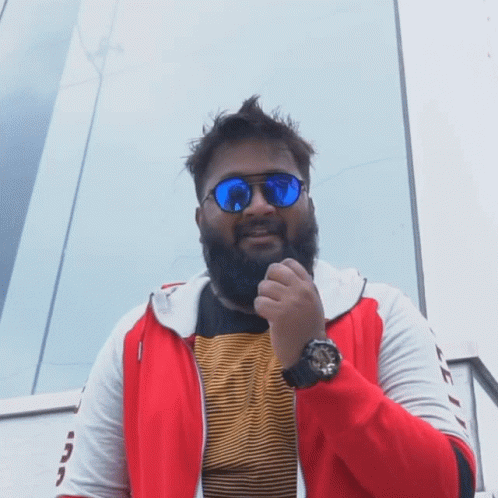A Man With A Beard Wears Sunglasses And A Watch GIF