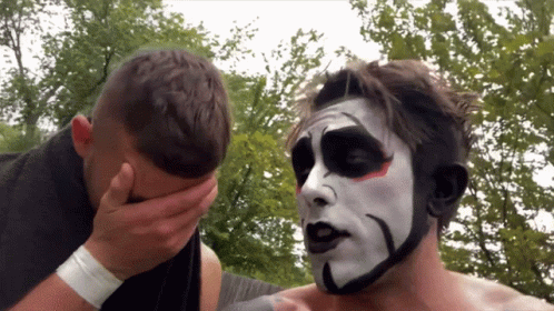 a man with a black and white face paint covering his face