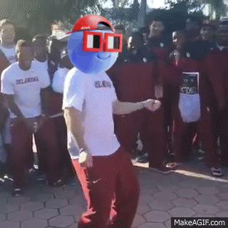 A Man With A Blue Ball On His Head Is Dancing In Front Of A Crowd Of People Wearing Oklahoma Shirts GIF