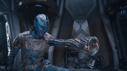 A Man With A Blue Face Is Holding A Light In His Hand . GIF