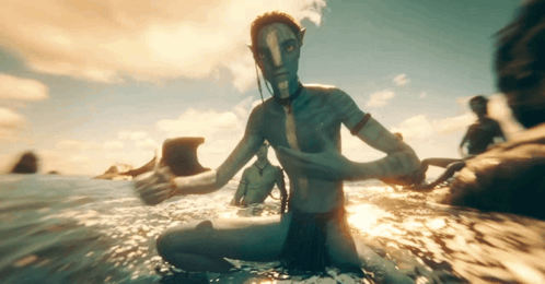 A Man With A Blue Face Is Sitting In The Ocean GIF