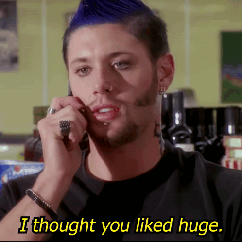 A Man With A Blue Mohawk Is Talking On A Cell Phone And The Caption Says I Thought You Liked Huge GIF