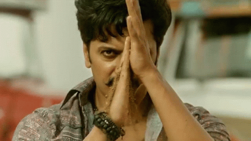 A Man With A Bracelet On His Wrist Holds His Hands In Front Of His Face GIF