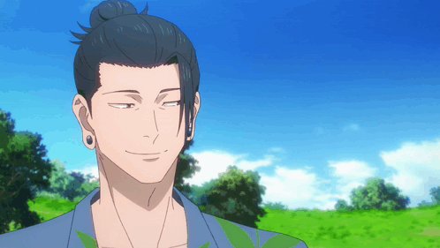 A Man With A Bun On His Head Stands In A Field With Trees In The Background GIF