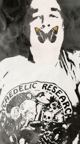 A Man With A Butterfly On His Face Is Wearing A Shirt That Says " Ephedelic Research " GIF