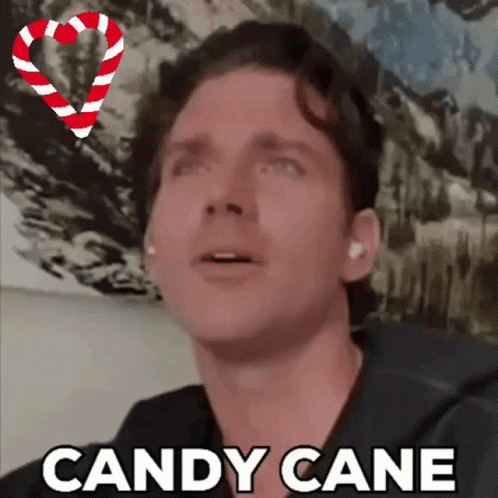 A Man With A Candy Cane In The Background GIF
