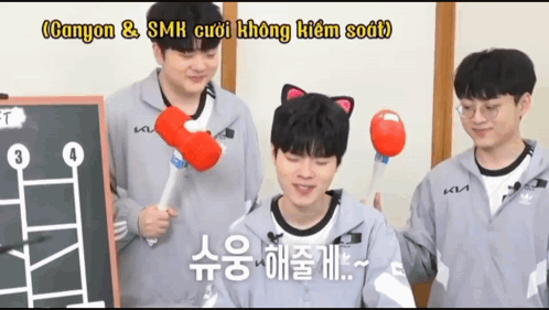 A Man With A Cat Ear On His Head Holds A Red Ball In His Hand GIF