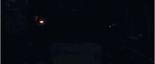 A Man With A Cross On His Back Is Holding A Torch GIF