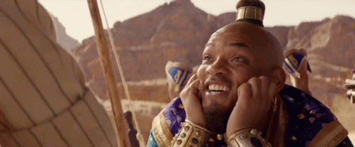 A Man With A Crown On His Head Is Smiling GIF