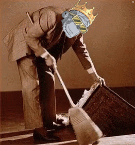 A Man With A Crown On His Head Is Sweeping The Floor With A Broom GIF