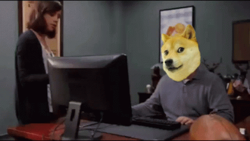 A Man With A Doge Head Sitting In Front Of A Computer Monitor GIF