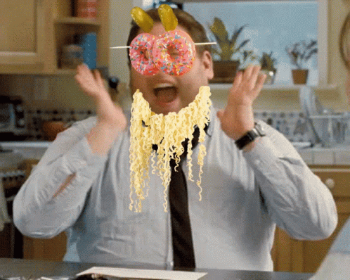 A Man With A Donut On His Face And Noodles On His Face GIF
