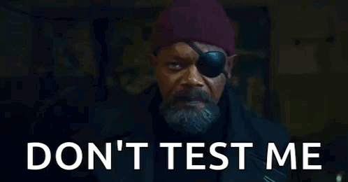 A Man With A Eye Patch And A Beard Is Standing In Front Of A Door . GIF