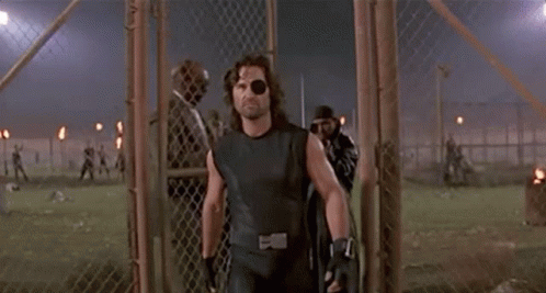 Man With Eye Patch Walking Through Fence GIF