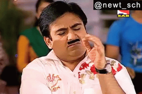 A Man With A Fake Mustache Is Making A Funny Face With His Hand . GIF