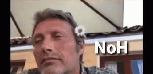 A Man With A Flower In His Hair And The Word " Noh " Below Him GIF