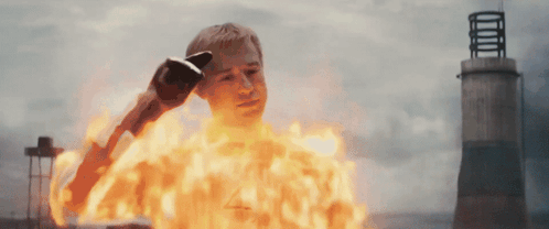 A Man With A Glove On His Head Is On Fire GIF