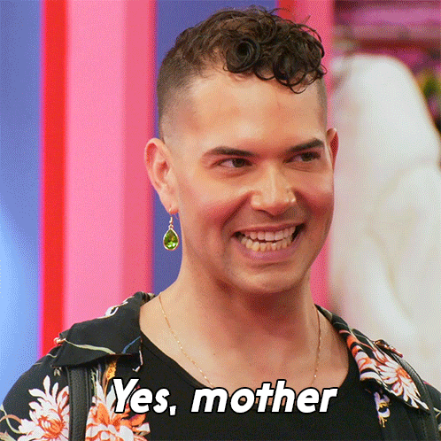A Man With A Green Earring Is Smiling And Says " Yes Mother " GIF