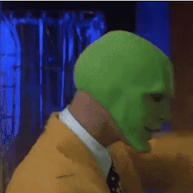A Man With A Green Mask On His Face Wearing A Cowboy Hat GIF