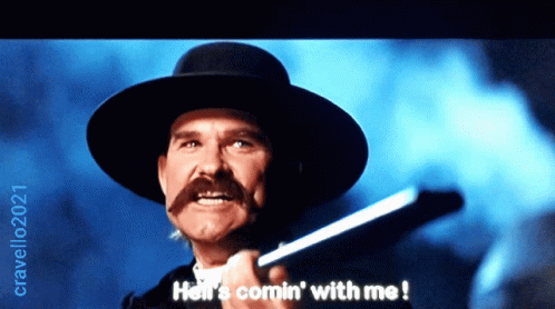 A Man With A Hat And A Mustache Is Holding A Gun And Says Hell 'S Comin ' With Me GIF