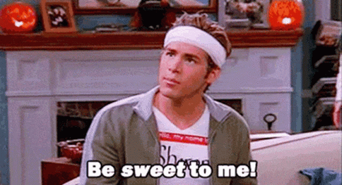 A Man With A Headband On His Head Is Sitting On A Couch . GIF