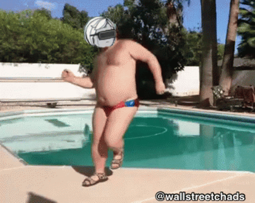 A Man With A Helmet On His Head Is Jumping Into A Pool GIF